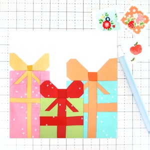 May include: Three fabric gift boxes with bows. The boxes are pink, green, and blue with white polka dots. The bows are yellow, red, and orange.