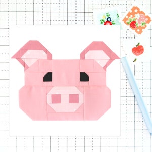 May include: A pink pig face made from fabric squares. The pig has black eyes, a pink snout, and pink ears.