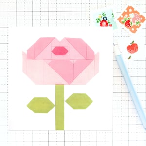 May include: A pink paper flower with a green stem and leaves. The flower is made of squares and triangles.