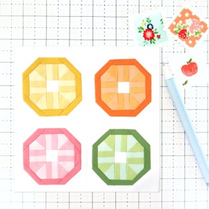 May include: Four octagonal paper shapes with a white center and a pattern of alternating colors. The shapes are yellow, orange, pink, and green.