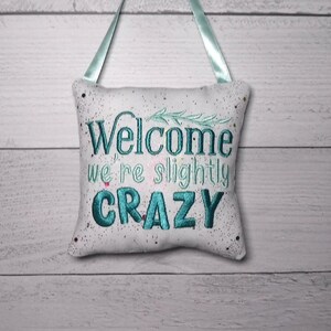 Embroidered "Welcome We're Slightly Crazy" Door Knob Hanger