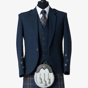 May include: A navy blue Scottish kilt outfit, including a jacket, vest, and kilt. The jacket has buttoned cuffs and a two-button closure. A white sporran with tassels hangs from the kilt. The kilt features a plaid pattern. A white dress shirt and patterned tie complete the ensemble.