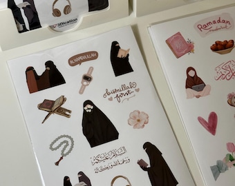 May include: Sheets of stickers featuring illustrations of women in traditional Islamic attire, along with religious symbols, floral accents, and Arabic calligraphy. The stickers include the text "ALHAMDULILLAH", "bismillah first", and "Ramadan".