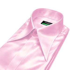 May include: A pale pink satin shirt, folded neatly, with a distinctive wide collar. The shirt features a buttoned front and a label on the collar. The fabric's sheen suggests a formal garment, suitable for special occasions.