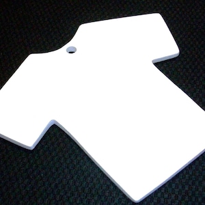May include: White blank t-shirt shaped ornament with a hole at the top for hanging.