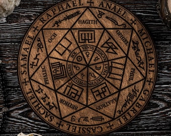 May include: A wooden, circular decorative piece with engraved symbols and text, including names like Raphael and Michael. The image also features lit candles, a rosary, a small skull, and a bird skull, all arranged on a dark, wood-grain surface.