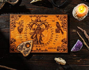 May include: A wooden Ouija board with engraved letters, numbers, and a central illustration of a woman. The board is surrounded by a planchette, a bird skull, a lit candle, and other mystical items. The board is approximately 30 cm long.