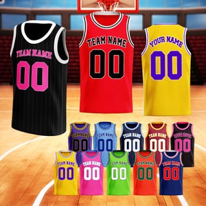May include: A collection of basketball jerseys in various colors, including black, red, and yellow. Each jersey features a team name and the number "00" in a contrasting color. The jerseys are displayed on a basketball court.