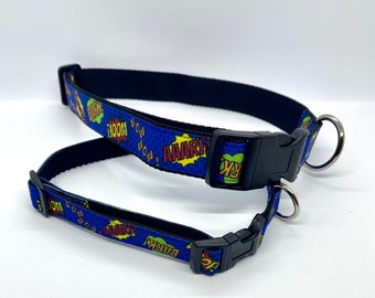 May include: Two blue and black dog collars with a comic book style print featuring words like "BOOM", "POW", "AARGH", and "BARK".