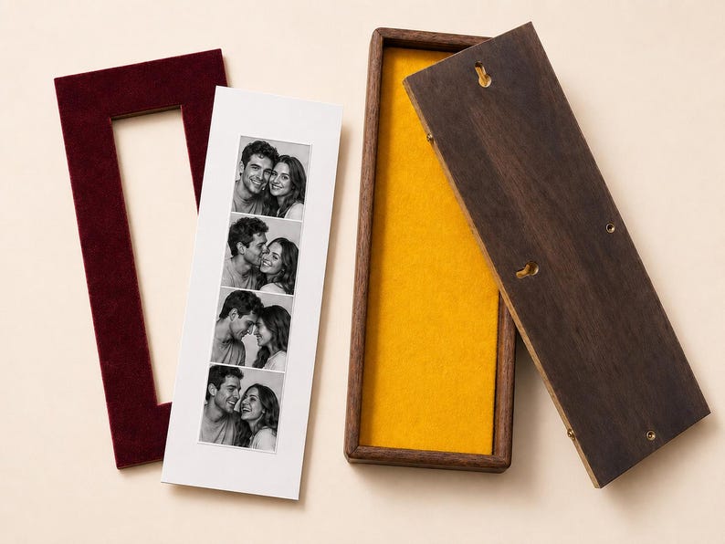 May include: A rectangular dark wood display box with a bright yellow interior lining, a matching dark wood lid with two keyhole slots, and a separate maroon velvet mat frame containing a vertical photo strip of a couple in black and white.