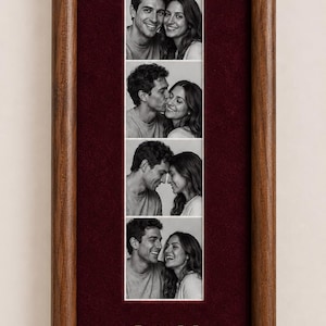 May include: A vertical wooden picture frame with a deep red velvet mat containing four black and white photographs of a couple in various poses. Below the photos, the gold-colored letters J and M are separated by a small gold heart symbol.