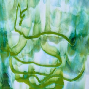 May include: A rectangular piece of art glass with a white base, swirled with shades of green and blue. A green outline of a rabbit is visible. The edges are uneven. Small stickers are on the top right corner.