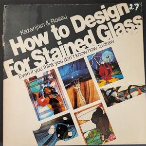 May include: A square softcover book titled How to Design For Stained Glass by Kazanjian & Rosey. The cover features a cream background with bold black text and six colorful rectangular illustrations depicting various stained glass art designs.