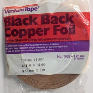 May include: A roll of Venture Tape Black Back Copper Foil in clear plastic packaging. The label reads Black Back Copper Foil for the Stained Glass Artisan/Craftsperson, No. 1765, 1.25 mil, 3/8 IN X 36 YDS, and 9.53 mm X 33 M.