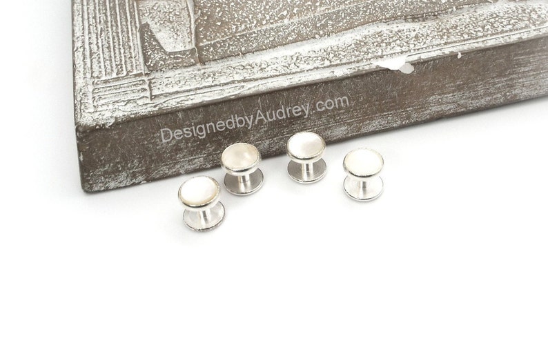 May include: Set of four silver cufflinks with white mother of pearl inserts.
