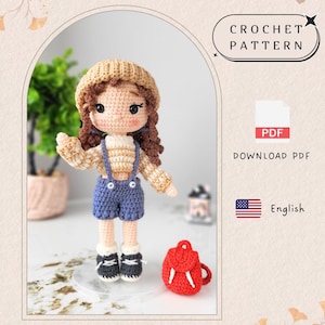 以下が含まれることがあります： ベージュの帽子、ストライプのセーター、青いオーバーオール、白と黒の靴を履いたかぎ針編みの人形。小さな赤いバックパックが近くにあります。「CROCHET PATTERN」と「DOWNLOAD PDF」の文字が含まれています。