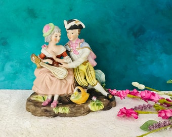 Vintage Royal Crown Victorian courting couple with instruments Figurine