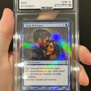 May include: A graded trading card featuring the text "Tom & Grace" and an image of a couple. The card is encased in a clear plastic holder with the text "MADISON & SAM 2025" and "AUTHENTIC GEM 10". The card has the text "Endless Love" and a quote.