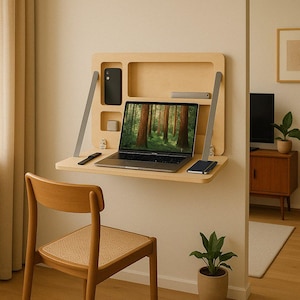 May include: A light wood wall-mounted desk with a laptop, phone, and a notebook. The desk has a shelf above the work surface. A wooden chair sits in front of the desk.