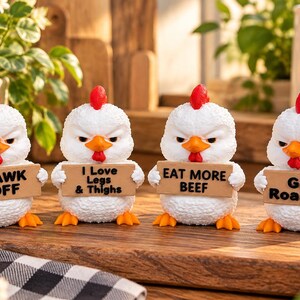 May include: Four white chicken figurines with red combs and orange beaks, each holding a small wooden sign. The signs feature the text BAWK OFF, I Love Legs & Thighs, EAT MORE BEEF, and Get Roasted in black lettering.