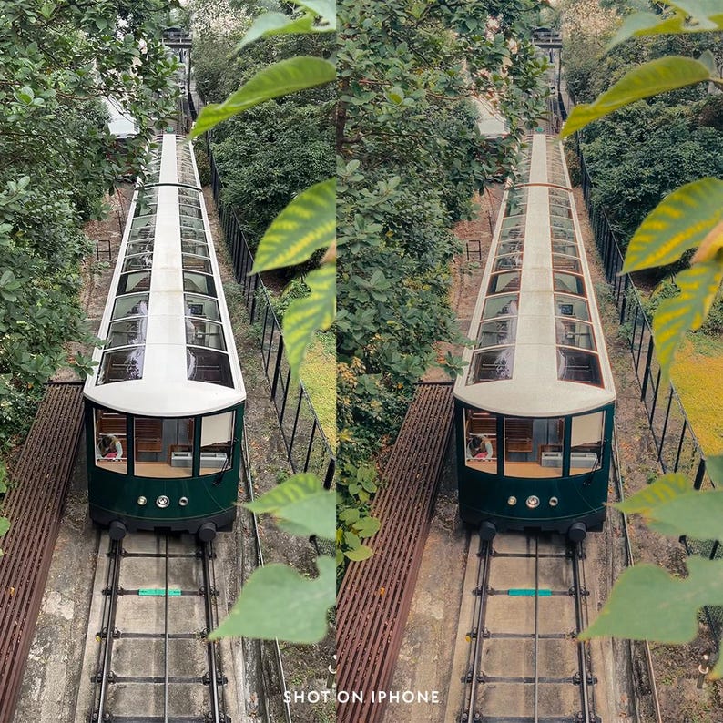 May include: Two green and white funicular cars ascend a steep track, viewed from above. The cars have glass roofs and are surrounded by lush greenery. The image is framed by leaves and the text "SHOT ON IPHONE" is visible at the bottom.