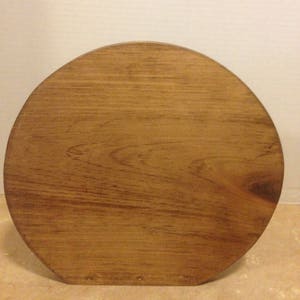 May include: A round wooden base with a smooth, dark brown finish. The base is made of solid wood and has a natural grain pattern.