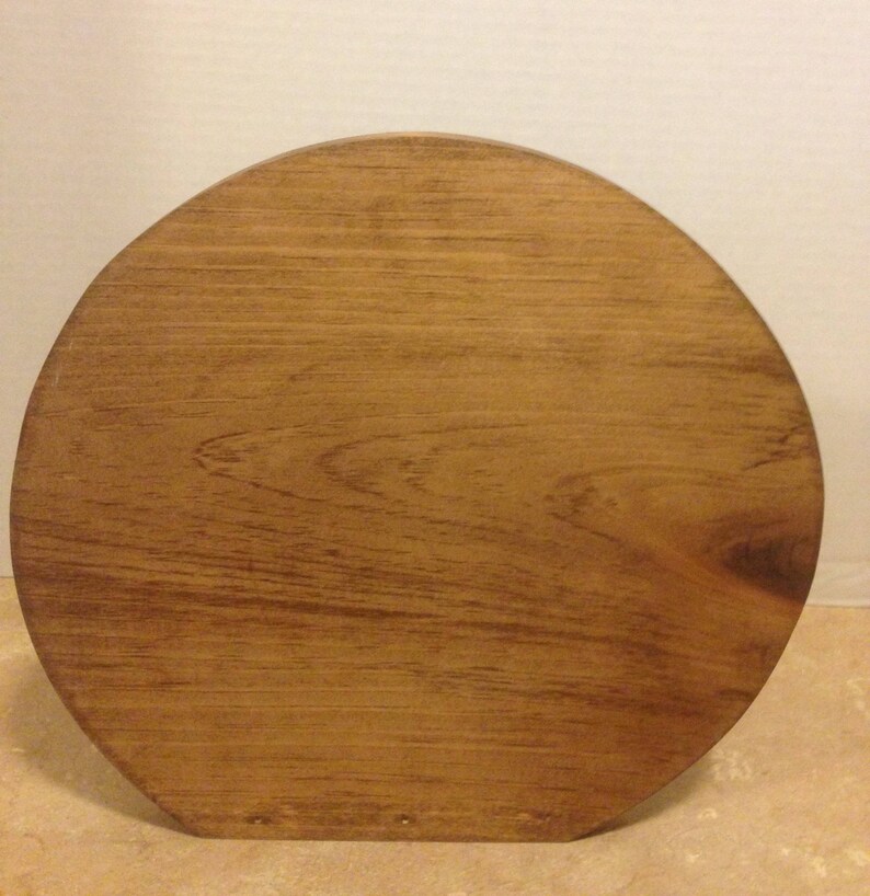 May include: A round wooden base with a smooth, dark brown finish. The base is made of solid wood and has a natural grain pattern.