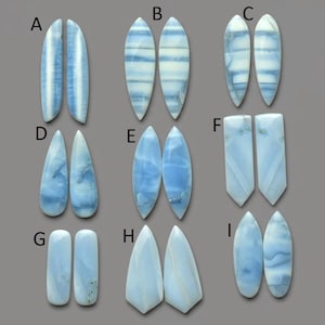 May include: A white ceramic mug with a black handle and the text "But First, Coffee" in a bold, black font. The mug is set against a blurred background, suggesting a cozy setting.