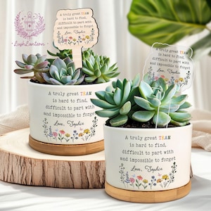 May include: Two white ceramic succulent planters with bamboo saucers. Each planter has a message that reads "A truly great TEAM is hard to find, difficult to part with and impossible to forget. Love, Sophia." One planter has a wooden sign.
