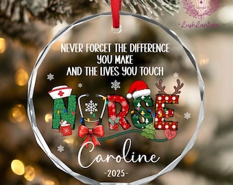 May include: A clear, round Christmas ornament with the word "NURSE" decorated with festive designs. The ornament features the text "NEVER FORGET THE DIFFERENCE YOU MAKE AND THE LIVES YOU TOUCH" and the name "Caroline" with the year "-2025-".