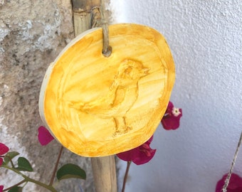 Handmade ceramic pendants hanging wall decor inspired by nature with bird linocut design and tree leaves
