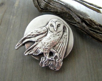 May include: A silver owl pendant with a detailed design, perched on a branch. The owl is facing forward with its wings spread out.
