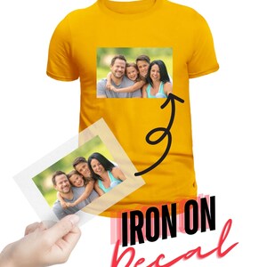 May include: A yellow t-shirt with a photo of a family of four on it. The photo is on an iron-on decal that is being applied to the shirt.