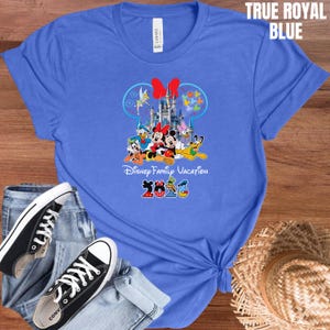 May include: A white ceramic mug with a black handle and the text "But First, Coffee" in a handwritten style. The mug is on a white surface. The mug is approximately 4 inches tall.