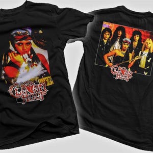 May include: Black t-shirts with a rock band graphic. The front of the shirt features a woman with red and white accents, and the text "Loverboy". The back of the shirt has a group of people and the text "Loverboy".