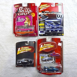 May include: Four Johnny Lightning die-cast toy cars in original blister packaging. Includes a pink 1967 Plymouth GTX, a blue 1971 Plymouth GTX numbered 46, a black muscle car, and a blue 1971 Plymouth GTX, all featuring detailed metal bodies.