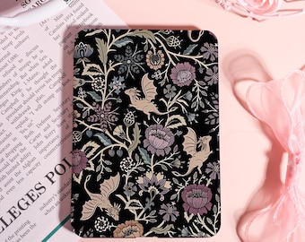 May include: A black rectangular case with a floral and dragon pattern. The design features stylized dragons, flowers, and foliage in shades of purple, beige, and green against a black background. The case is likely for a phone or tablet.