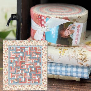 May include: A fabric roll bundle featuring the Countryside by Lisa Audit collection for Riley Blake Designs, tied with a white ribbon. Beside it is a rectangular quilt pattern illustration titled Apron Strings Quilt Kit with floral, plaid, and geometric fabric blocks in shades of red, blue, and cream.