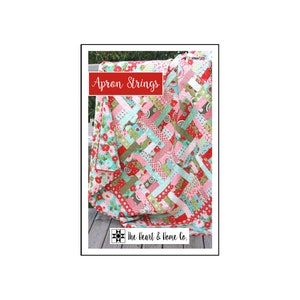 May include: A colorful quilt pattern called "Apron Strings" by The Heart & Home Co. The quilt is made with a variety of fabrics in shades of red, pink, green, and blue.