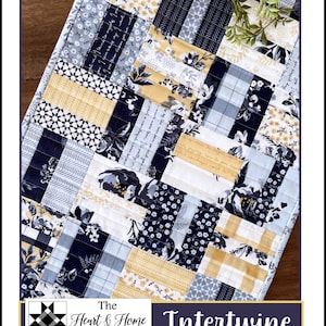 May include: A quilting pattern for a table runner called "Intertwine" by The Heart & Home Company. The pattern features a patchwork design with blue, yellow, and white fabrics.