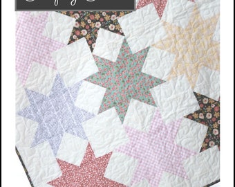 May include: A quilt pattern featuring a patchwork of stars in various floral and gingham prints. The quilt is titled "Simply Stars" and is designed by The Heart & Home Co. The pattern number is HNH209.