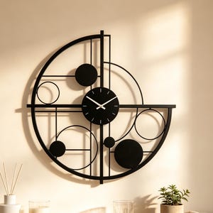 May include: A black metal wall clock featuring a geometric design with a central circular clock face, thin straight lines, and various solid and open circles arranged in an asymmetrical pattern against a plain wall surface.
