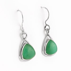 May include: A pair of silver dangle earrings with green gemstone drops. The earrings have a twisted wire design.