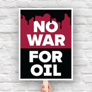 May include: A protest sign with the words "NO WAR FOR OIL" in bold white letters. The top half of the sign is maroon with black dripping paint, and the bottom half is black. The sign is held by a wooden stick.