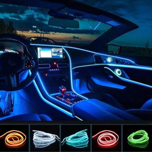 May include: A car interior illuminated with blue LED lights. The lights are installed along the dashboard, door panels, and center console. The image also shows five spools of LED lights in different colors: orange, white, blue, red, and green.