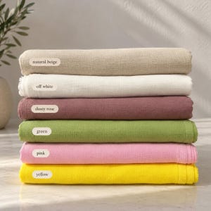 May include: A stack of six folded fabric pieces in natural beige, off white, dusty rose, green, pink, and yellow. Each piece features a label with its color name: natural beige, off white, dusty rose, green, pink, and yellow.