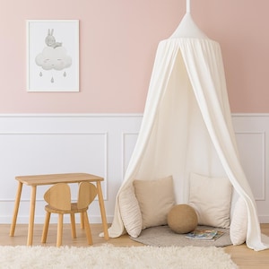 May include: A children's room scene featuring a wooden table and chair set, a white canopy, and a framed print of a bunny on a cloud. The room has a pink wall and a white rug. The table is 24 inches long.
