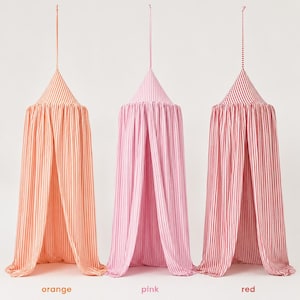 May include: Three hanging fabric canopies with a conical top and long, flowing drapes. Each canopy features vertical stripes in orange, pink, or red, alternating with white. A thin fabric loop extends from the top of each canopy for suspension.