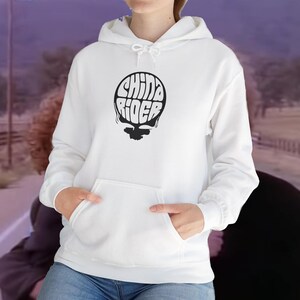 May include: White hooded sweatshirt with a black graphic of the words "China Rider" in a circular design.
