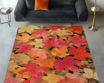 May include: A rectangular rug with a colourful autumn leaf pattern. The rug displays a mosaic of red, orange, and gold maple leaves with detailed vein patterns. The leaves are spread across a brown background, creating a warm and inviting aesthetic.